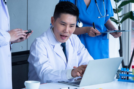 Doctor and medical assistants discussing about diagnosis result on x-ray film.