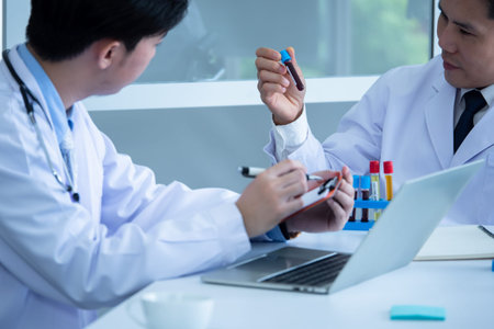 Scientist discussing with colleague about covid 19 vaccine in meeting room at hospital