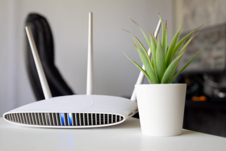 Close up of a wireless router on table at home with desktop computer background
