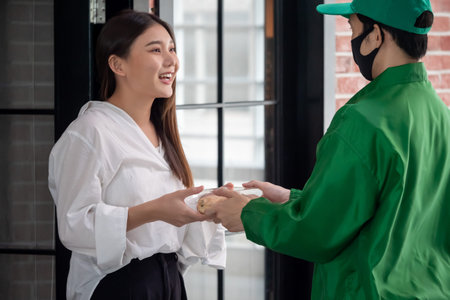 Happy woman recieving food from food deliveryman