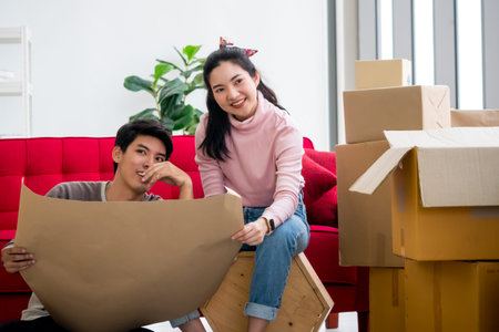 Happy young couple moving to new house together.