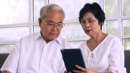 Asian elderly couple spending time together at home.の写真素材