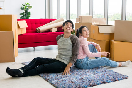 Happy young couple moving to new house together.