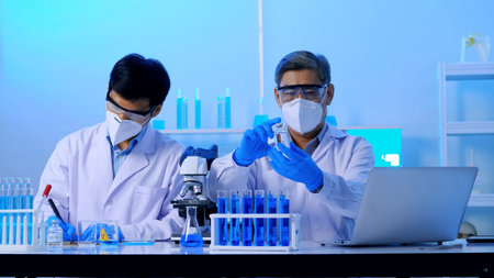 Group of Asian scientists doing some research in the laboratory.