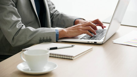Businessman working with documents and laptop on the desk.