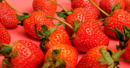 Close up, Bright red and sweet ripe many strawberries on red background.