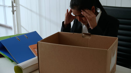 Young businesswoman is stressed because of being fired from her job.