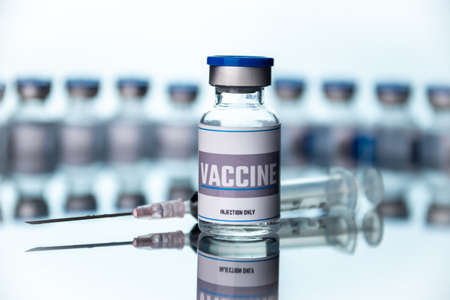 Glass vials for vaccine and syringe in laboratory. Group of vaccine bottles. Medicine in ampoules.の写真素材