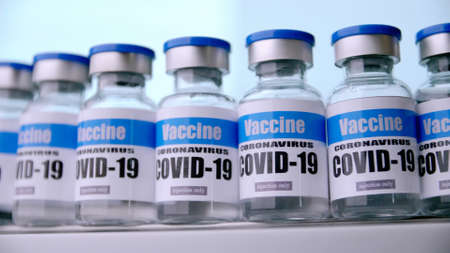 Glass vials for Covid-19 vaccine in laboratory. Group of Coronavirus vaccine bottles. Medicine in ampoules.の写真素材