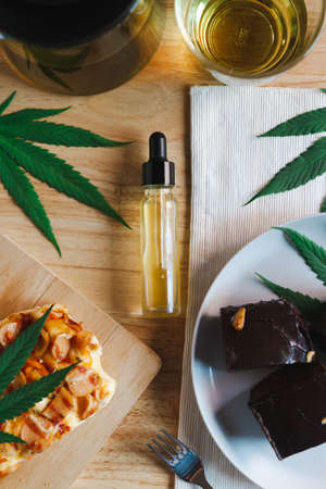Food and drink and cannabis oil on the dining table. Alternative medicine concept.の写真素材