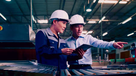 An engineer is explaining remote machine control to industrial owners.の写真素材