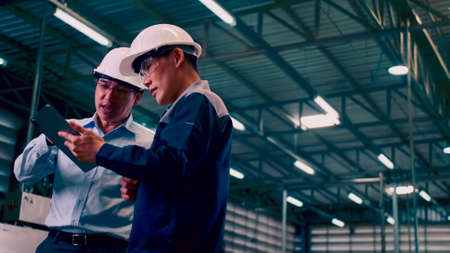 An engineer is explaining remote machine control to industrial owners.の写真素材