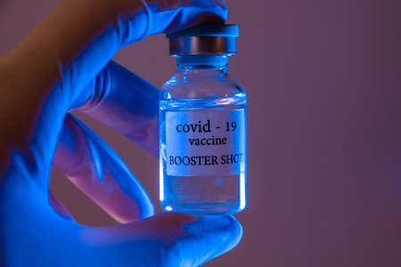 COVID-19 booster vaccine vial. Medicine and health care concept