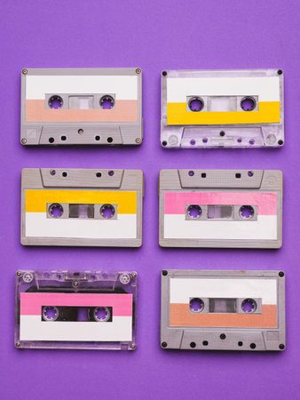 Collection of cassette tapes on purple background.