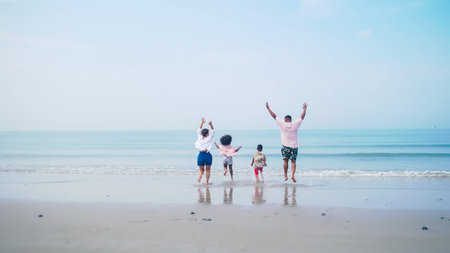 Family having fun playing together on the beach.