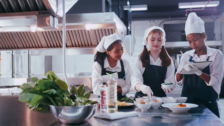 Group of schoolgirls having fun learning to cook. Female students in a cooking class.
