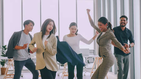 Business people celebrating by dancing at a meeting in office.の写真素材