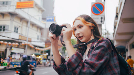 A beautiful woman tourist enjoys taking photos of the city view in Bangkok, Thailand.の写真素材