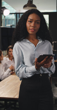 Young beautiful businesswoman working on tablet in office.の写真素材