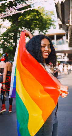 A young black woman shows off her homosexual identity in a pride parade.の写真素材