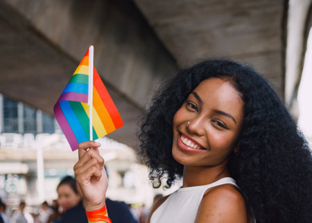 A young black woman showing symbols of homosexuality in pride parade.の写真素材