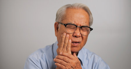 Asian elderly man suffering from toothache.の写真素材