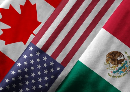 Close up of the flags of the North American Free Trade Agreement NAFTA members on textile texture. NAFTA is the world's largest trade bloc and the member countries are Canada, United States and Mexico.の写真素材