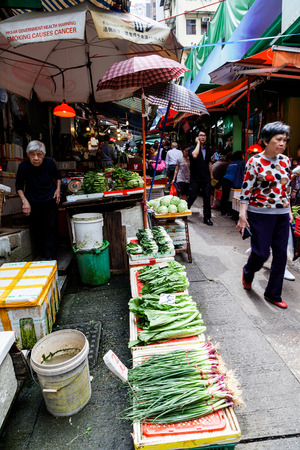 Shoppers patronize the fruit and vegetable stores along Graham Street in the Central District of downtown Hong Kong for the last time. The popular area was Hong Kong's oldest continuously operating street market for more than 160 years until Apr. 1 2015 wのeditorial素材