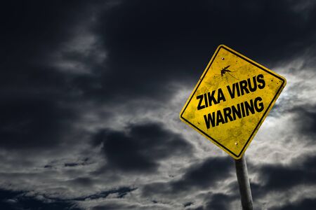Zika virus warning sign against a stormy background with dirty and angled sign for drama.の写真素材
