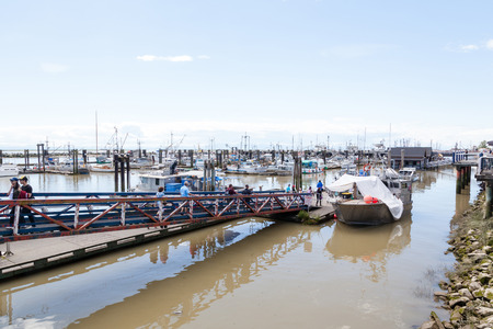 RICHMOND, CANADA - JULY 10: Visitors at the picturesque seaside village of Steveston in Richmond near Vancouver July 10, 2016. Here, the popular Fisherman's Wharf offers fresh seafood, many eateries and unique shops, many of which feature handmade productのeditorial素材