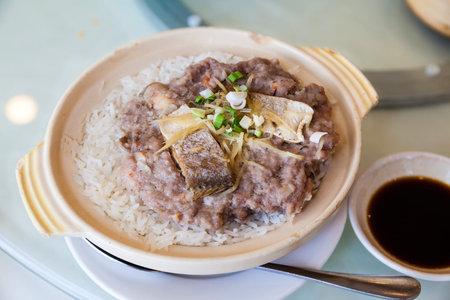 Chinese steamed pork with salted fish rice in claypot is a popular dish in Cantonese dim sum restaurants in Hong Kong and Southern China.の写真素材