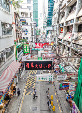 Hong Kong, China - March 30, 2015:  Multiple street billboard ads hang on rafters along a busy street in the downtown Central District of Hong Kong Island. The business hub of the city, Central bustles with shoppers and tourists because of its many restauのeditorial素材