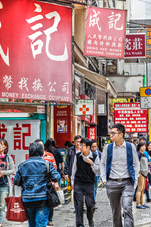 Hong Kong, China - March 30, 2015: Busy crowd along a side street in Central District on Hong Kong Island. The area is renowned for its many restaurants and fashion boutiques.のeditorial素材