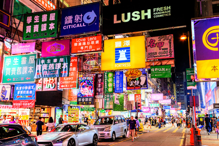 HONG KONG, JULY 10, 2017: Colorful billboard neon signs hang precariously on buildings along Nathan Road in Mongkok, one of the busiest and most popular commercial areas in Hong Kong and a favorite place for visitors and locals to hang out and explore.のeditorial素材