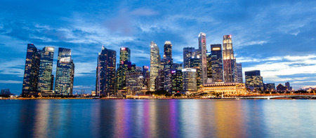 Panorama of Singapore skyline at Marina Bay during sunset blue hour showing skyscrapers in downtown central financial business district.のeditorial素材