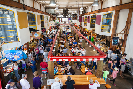 VANCOUVER, CANADA - AUG. 16, 2017: Visitors eating at the Granville Island Public Market. It's home to over 100 vendors offering fresh seafood, meats, and specialty foods. Granville Island is located across False Creek from downtown Vancouver.のeditorial素材