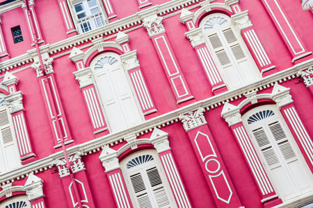 Red colonial-style building in Singapore Chinatown. These charming units were typical pre-World War II era architecture native to Singapore's heritage and culture.のeditorial素材