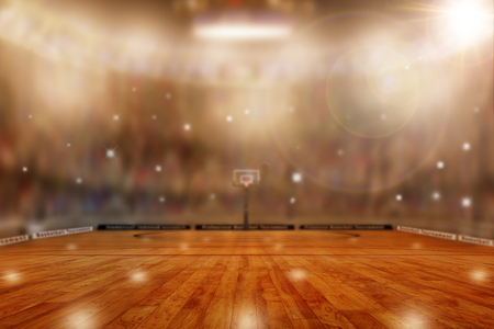 Low angle view of fictitious basketball arena with flashes from sports fans in the stands and lens flare effect. Focus on foreground with deliberate shallow depth of field on background and copy space.の写真素材