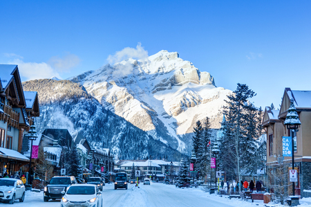 BANFF, CANADA - DEC 22, 2017: Winter scene on Banff Avenue in the Banff National Park with Cascade Mountain in the background. The townsite is a major Canadian tourist destination renowned for its mountainous surroundings and hot springs.のeditorial素材