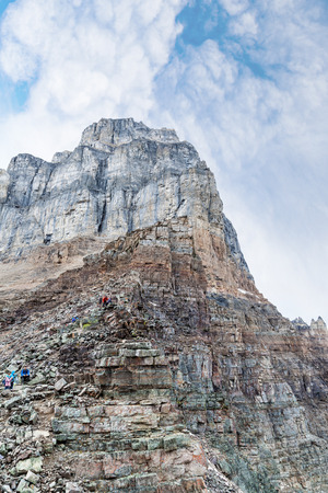 LAKE LOUISE, CANADA - SEP 17, 2016: Hikers resting near the peak of Pinnacle Mountain atop Sentinel Pass at Lake Louise in Banff National Park, Alberta.のeditorial素材
