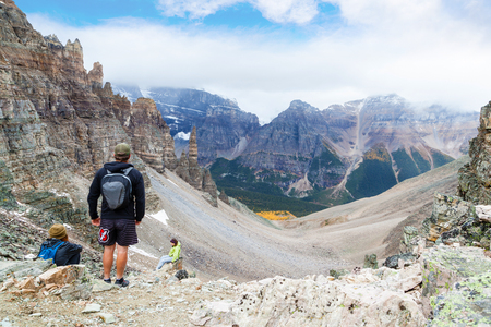 LAKE LOUISE, CANADA - SEPT 17, 2016: Hikers rest atop Sentinel Pass in the Larch Valley near Lake Louise in Banff National Park, Alberta, with Paradise Valley in the background.のeditorial素材