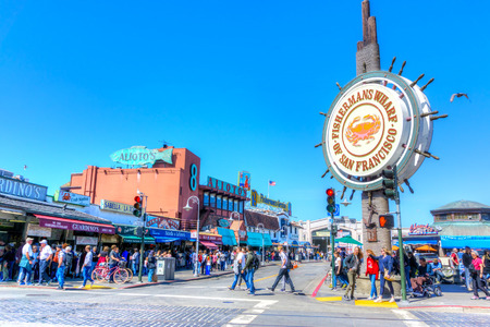 SAN FRANCISCO - APR 2, 2018: A crowd visiting the Fisherman's Wharf in San Francisco. The popular  waterfront district is famous for its many attractions, souvenir shops and stalls selling crab and clam chowder in sourdough bread bowls.のeditorial素材