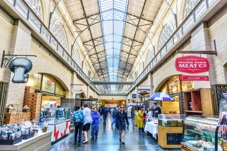 SAN FRANCISCO - APR 2, 2018: Shoppers visit the public marketplace at the historic Ferry Building in downtown San Francisco. Opened in 1898, the landmark building is a terminal for San Francisco Bay ferries and a farmers market.のeditorial素材