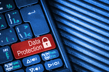 Close up of computer laptop keyboard with red button Data Protection concept and copy space. Idea of Internet security, data privacy, cyber crime prevention.の写真素材