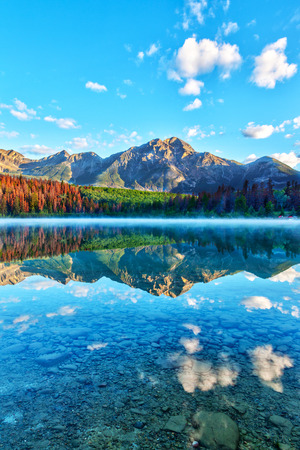 Sunrise over Patricia Lake in Jasper National Park with Pyramid Mountain in the background and misty fog on the water's surface. Calm waters create serene reflections.の写真素材