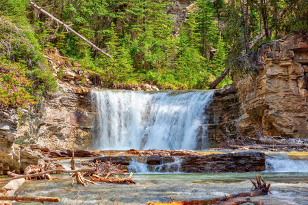 Waterfall flowing into Johnston Canyon creek at Banff National Park in Alberta, Canada. The waters empty into the Bow River.の写真素材
