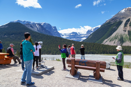 JASPER, CANADA - JUL 11, 2018: Tourists viewing the Stutfield Glacier on the Icefields Parkway in the Canadian Rockies. The glacier flows southeast from the Columbia Icefield at Stutfield Peak, a mountain in Jasper National Park, Alberta, Canada.のeditorial素材