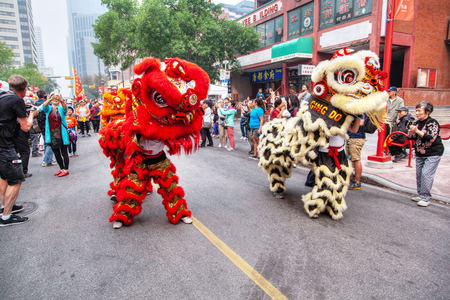 CALGARY, CANADA - SEP 4, 2018: A crowd watching a Chinese lion dancing parade along Chinatown in Calgary, Alberta, Canada, in celebration of Chinese festivities.のeditorial素材