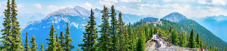 BANFF, CANADA - AUG 1, 2018: Visitors walk the wooden boardwalk on top of Sulphur Mountain between the Gondola summit and Sanson's Peak for a panoramic view of the mountain range in the Canadian Rockies of Banff National Park.のeditorial素材