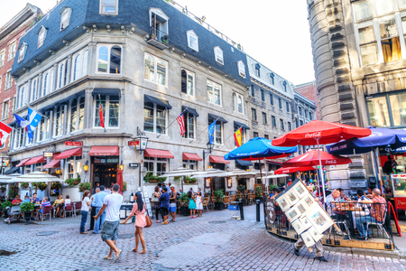 MONTREAL, CANADA - AUG 20, 2012: People meander at the junction of Rue Saint-Paul and Rue Saint-Vincent in the Old Montreal section of Montreal. They are the oldest streets in Montreal, Quebec, Canada, famous for the restaurants and unique shops.のeditorial素材